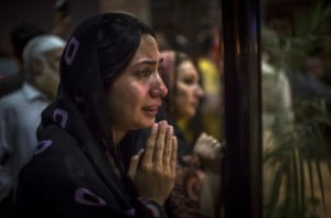  A woman believed to be a family member clasps her hands in prayer as people gather at the front doors of the Shaukat Khanum Memorial Cancer Hospital and Research Centre waiting to hear news of the medical condition of Imran Khan, chairman of the Pakistan Tehrik e Insaf (PTI) party, who was injured falling off a lifter during an election campaign rally on May 07, 2013 in Lahore, Pakistan. PTI chairman Imran Khan was injured at a rally in Lahore today after having fallen departing the stage. Pakistan's parliamentary elections are due to be held on May 11. Imran Khan of Pakistan Tehrik e Insaf (PTI) and Nawaz Sharif of the Pakistan Muslim League-N (PMLN) have been campaigning hard in the last weeks before polling. (Photo by Daniel Berehulak/Getty Images)